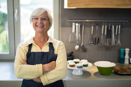 Portrait of senior women standing in the kitchenの写真素材