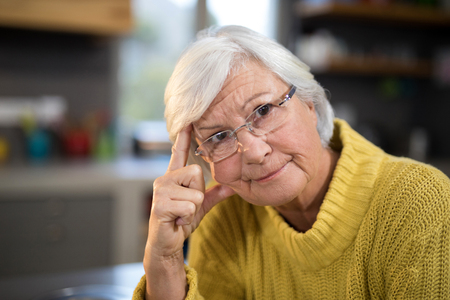 Close-up of worried senior woman in the kitchenの写真素材