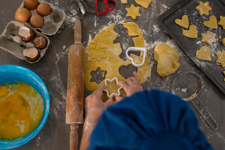 Cropped image of boy preparing cookies at kitchen counterの写真素材