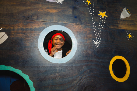 Portrait of smiling boy pretending to be a pirate at homeの写真素材
