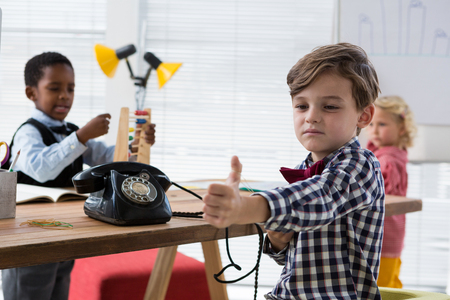 Coworkers working at table in creative officeの写真素材