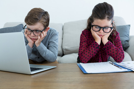 Business people working while sitting on sofa in creative officeの写真素材