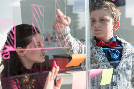 Business people analyzing graph on window seen through glass