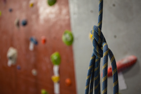 Close up of rope hanging against climbing wall at gymの写真素材