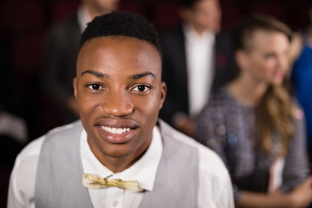 Portrait of man sitting in movie theatreの写真素材