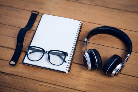 High agnle view of diary with personal accessories on tableの写真素材