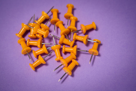 Yellow paper pins on purple paperの写真素材