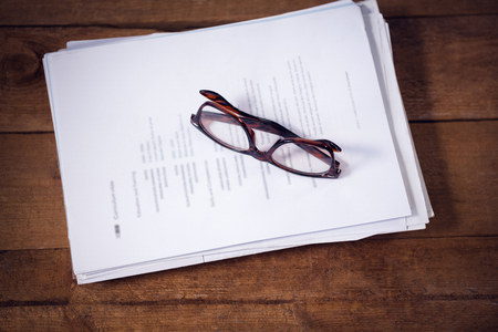 High angle view of eyeglasses on documents at table in office
