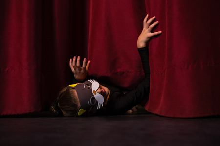 Ballet dancer wearing mask gesturing on the stageの写真素材