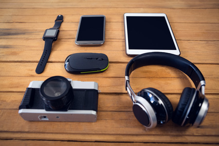 High angle view of technologies on wooden table in officeの写真素材