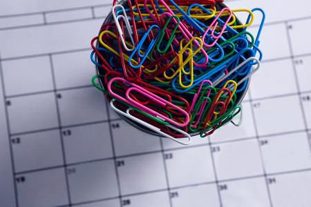 Close-up of colorful paper clips in bucketの写真素材