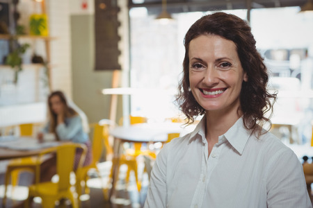Portrait of smiling young businesswoman in cafeの写真素材