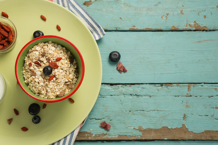 Close-up of oatmeal in bowl on a wooden tableの写真素材