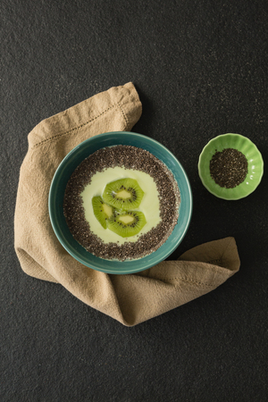 Sliced kiwifruit with milk in a bowl on concrete backgrouindの写真素材