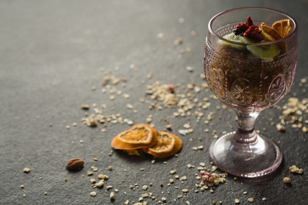 Dried fruits in glass on black backgroundの写真素材