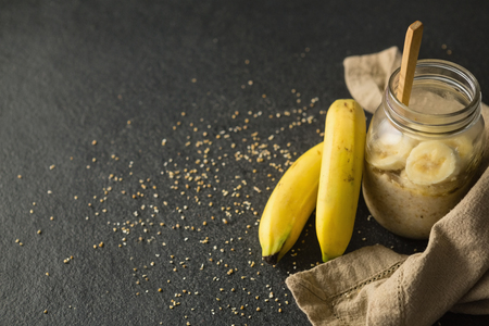 Fruit cereal in jar with napkin cloth on a concrete backgroundの写真素材