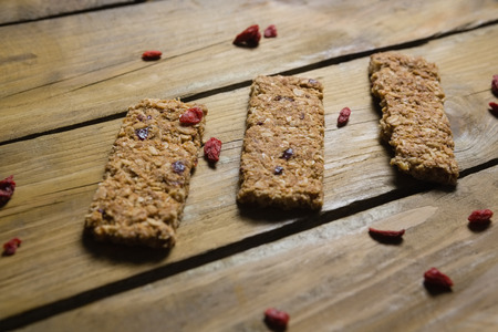 Close-up of three granola bars arranged on wooden tableの写真素材