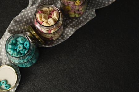 Three jars with various breakfast on black backgroundの写真素材