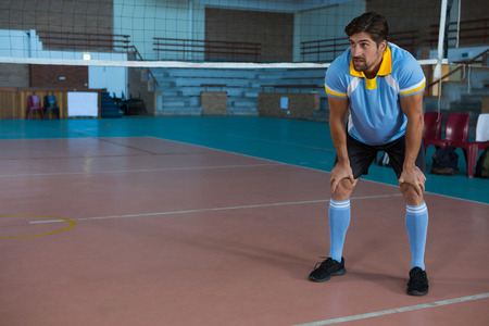 Full length of male volleyball player looking away at courtの写真素材