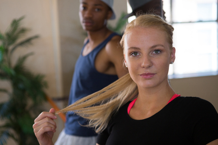 Portrait of beautiful female dancer with friend in studioの写真素材