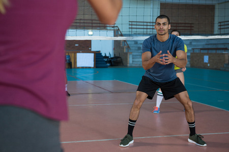 Full length of male player playing volleyball at court