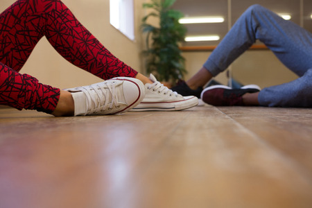 Low section of dancers on wooden floor in studioの写真素材