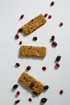 Overhead of granola bar with berries on white backgroundの写真素材