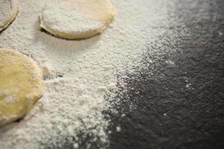 Cropped image of flour on unbaked cookies on tableの写真素材
