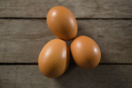 Directly above shot of brown eggs on wooden table