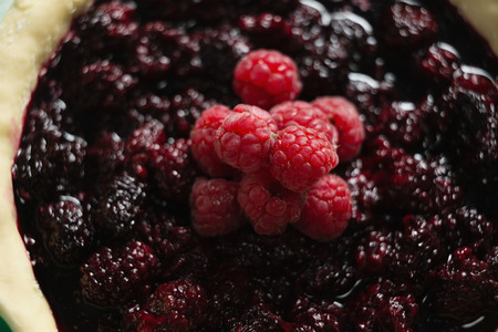High anlge view of raspberries and blackberries on tartの写真素材