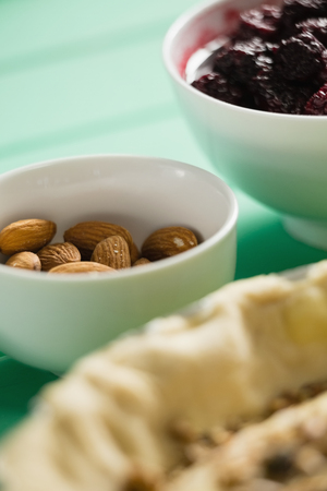 Almonds in bowl by trat on tableの写真素材