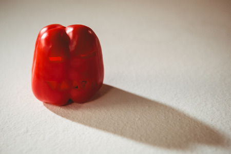 High angle view of carved red bell pepper over white backgroundの写真素材