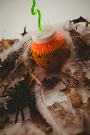 High angle view of drink in jack o lantern container with decorationsの写真素材