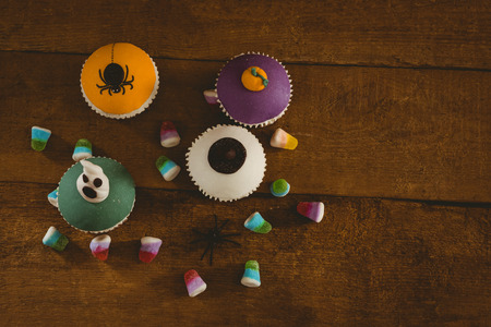 High angle view of cup cakes with sweet food on wooden tableの写真素材