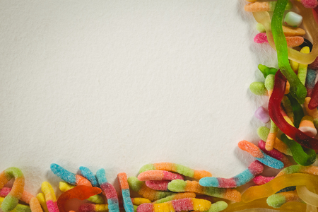 Overhead view of colorful jelly candies over white background