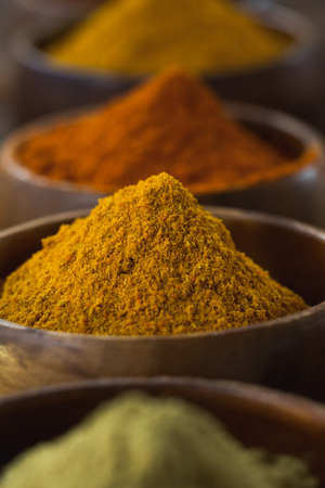 Close-up of various spice powder on wooden tableの写真素材