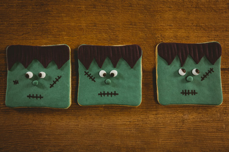 Close up of Halloween cookies arranged on wooden tableの写真素材