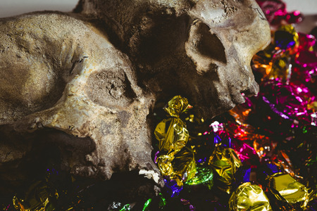 Close up of skull with colorful wrapped chocolatesの写真素材