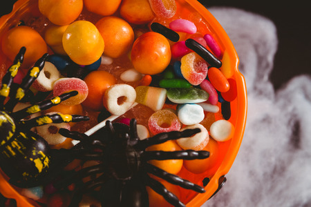 Overhead view of bucket with food and decoration over black backgroundの写真素材
