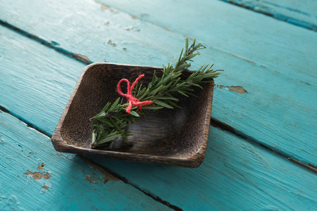 Close-up of tied rosemary in wooden bowlの写真素材