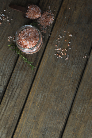 Overhead of himalayan salt and rosemary on wooden tableの写真素材