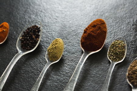 Close-up of various type spices on spoonの写真素材
