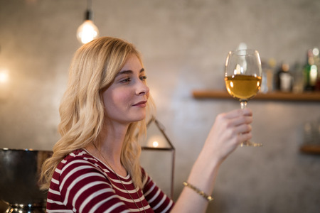Beautiful woman having wine in restaurantの写真素材