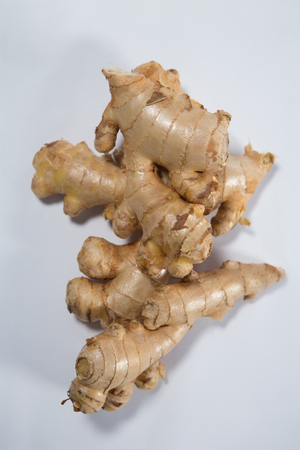 Overhead view of fresh gingers on white background