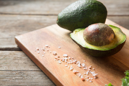 Close up of avocado and rock salt on cutting board