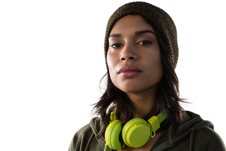 Close up portrait of confident young woman with headphones against white backgroundの写真素材