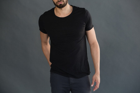 Mid-section of man posing against grey backgroundの写真素材