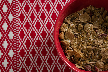Close-up of wheat flakes in bowl on napkinの写真素材