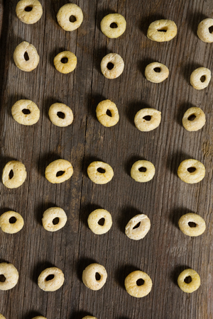 Apple jacks arranged in row on wooden tableの写真素材