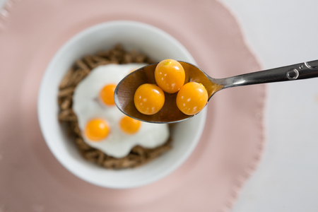 Close-up of golden berry in spoonの写真素材